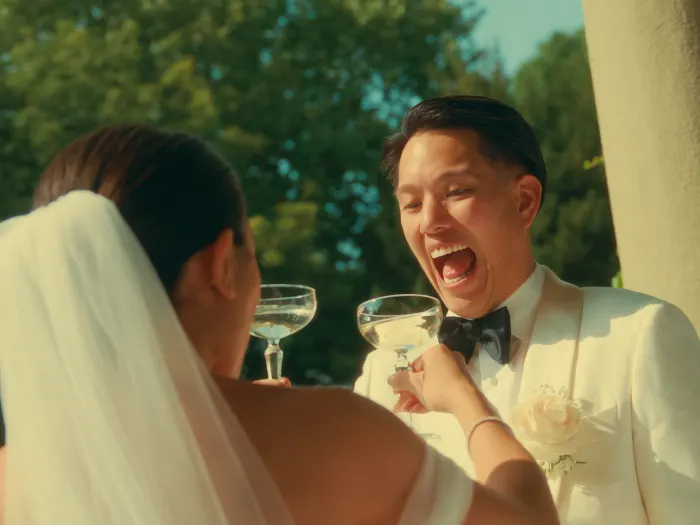 Ed laughing out loud while toasting with Elaine